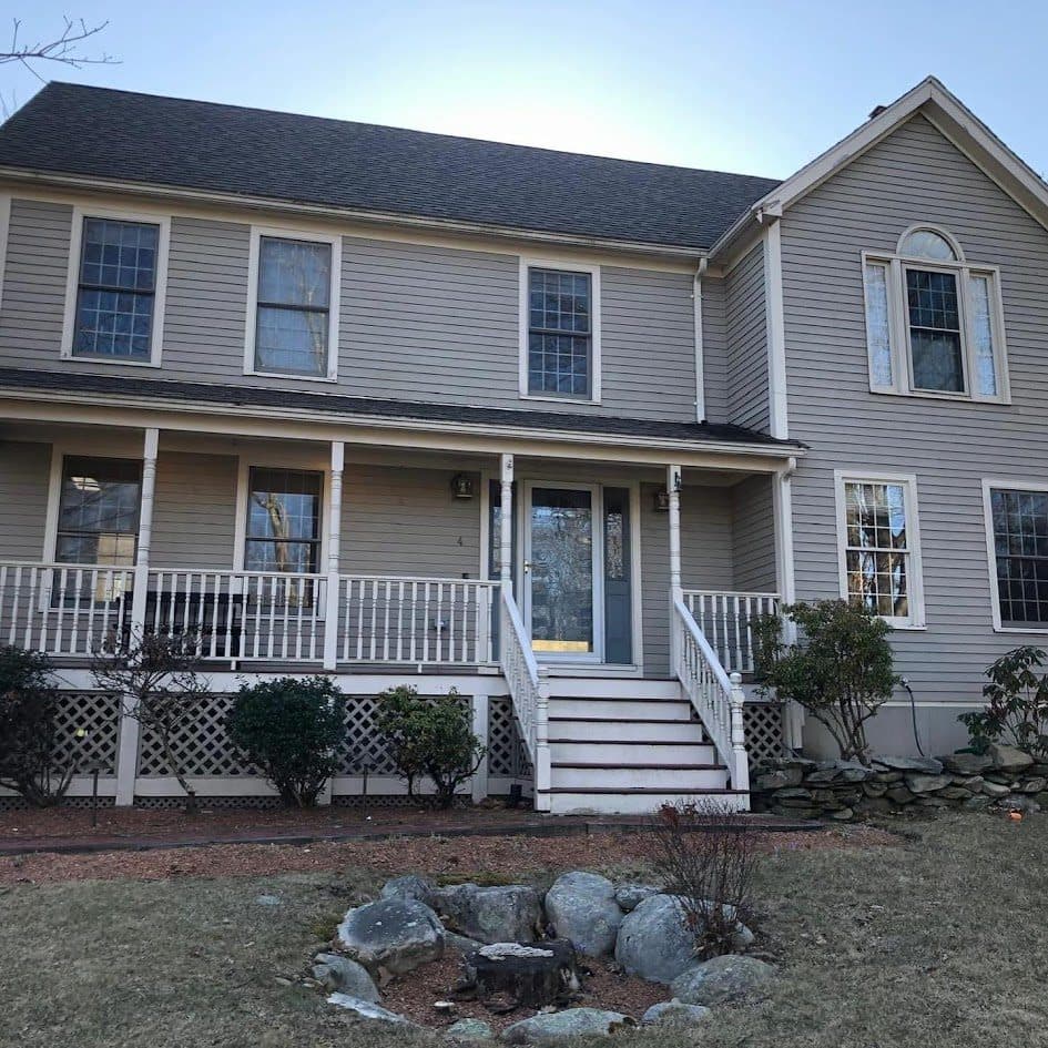 Beige colonial home exterior in Worcester County heading into a New England winter
