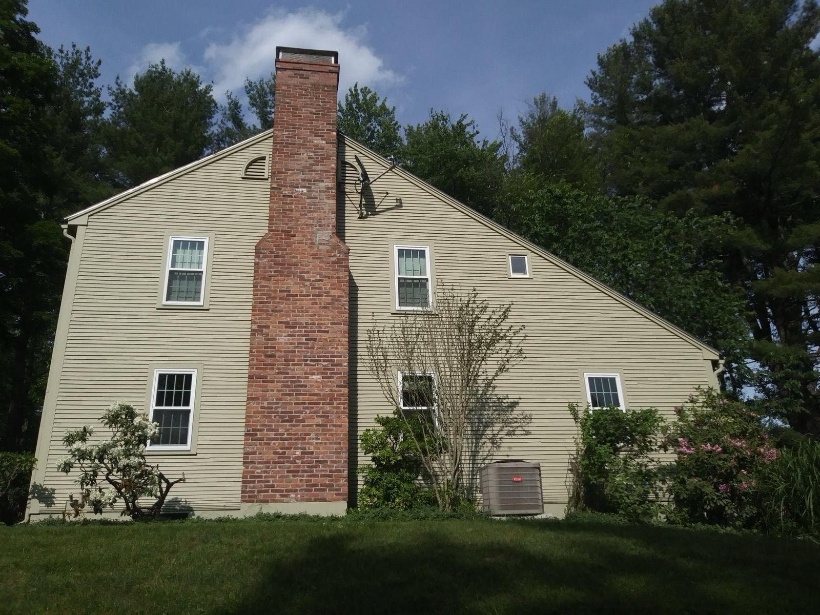 Cream colored house exterior on a clear summer day in Massachusetts