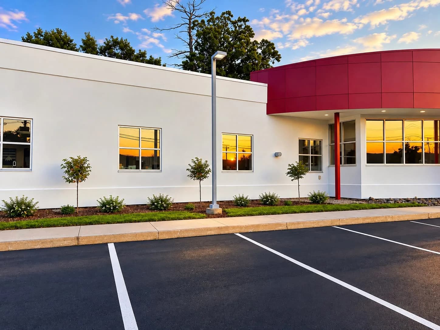 Commercial building exterior freshly repainted white with red canopy by George's Painting, Worcester County MA