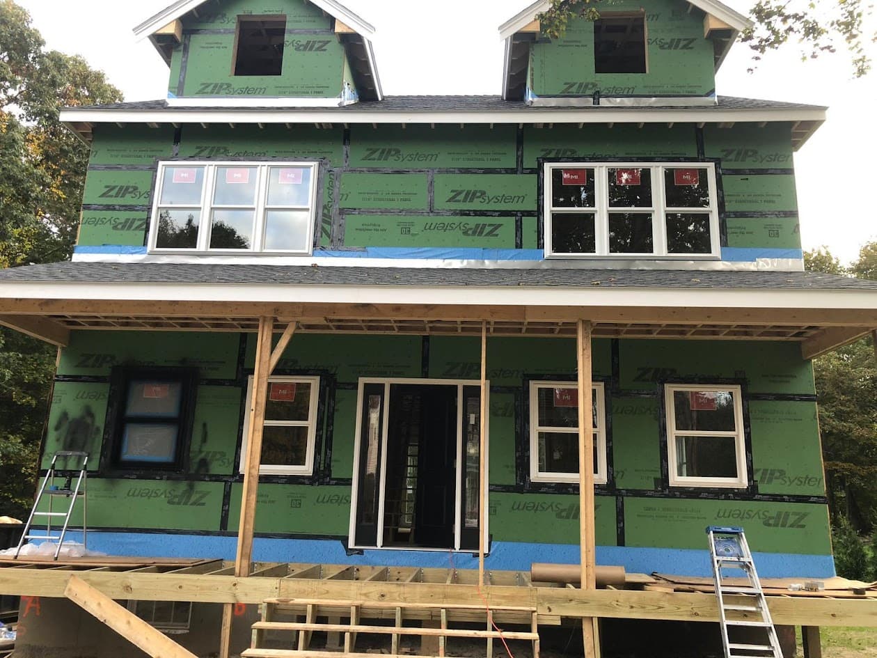House exterior being scraped, sanded, and prepped before a fresh coat of paint
